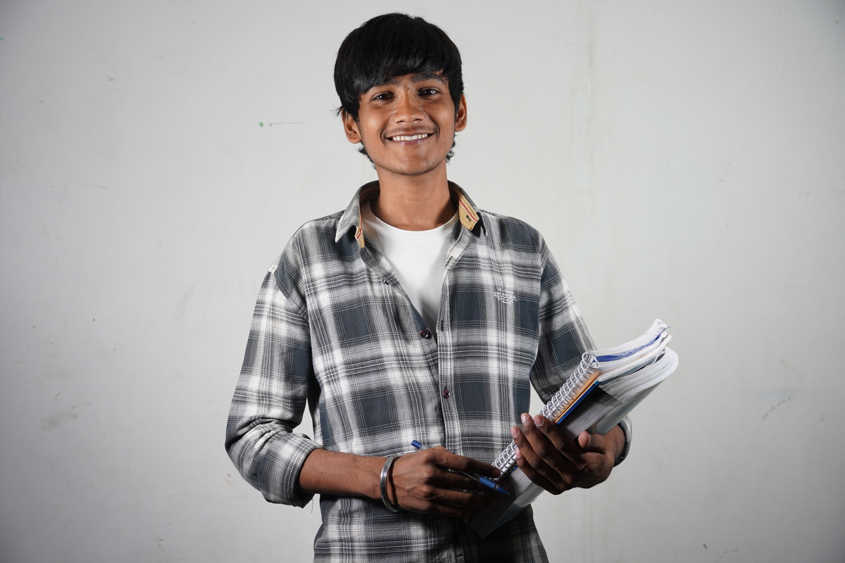 indian student with books going for college students